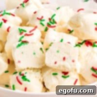 Creamy Cloud Bites 10 Close up looking at a bowl of Cool Whip Candy with a spoon, highlighting its creamy texture.