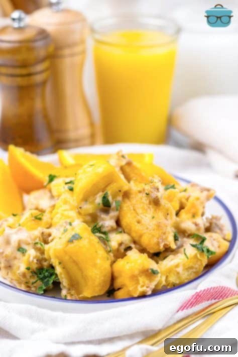 A serving bowl of Crock Pot Sausage Gravy Biscuit Casserole.