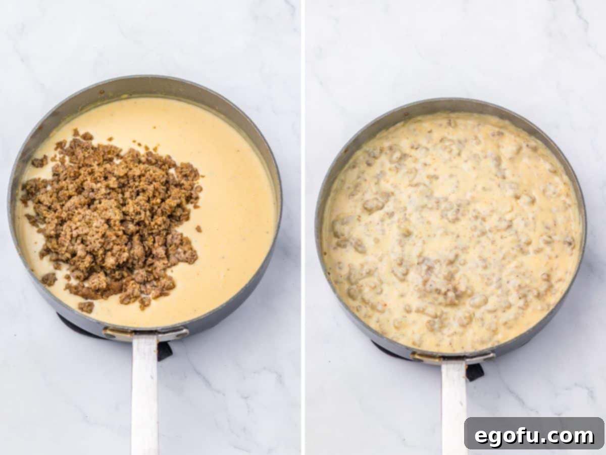 Sausage and gravy being mixed in a skillet, showcasing the rich, creamy texture.