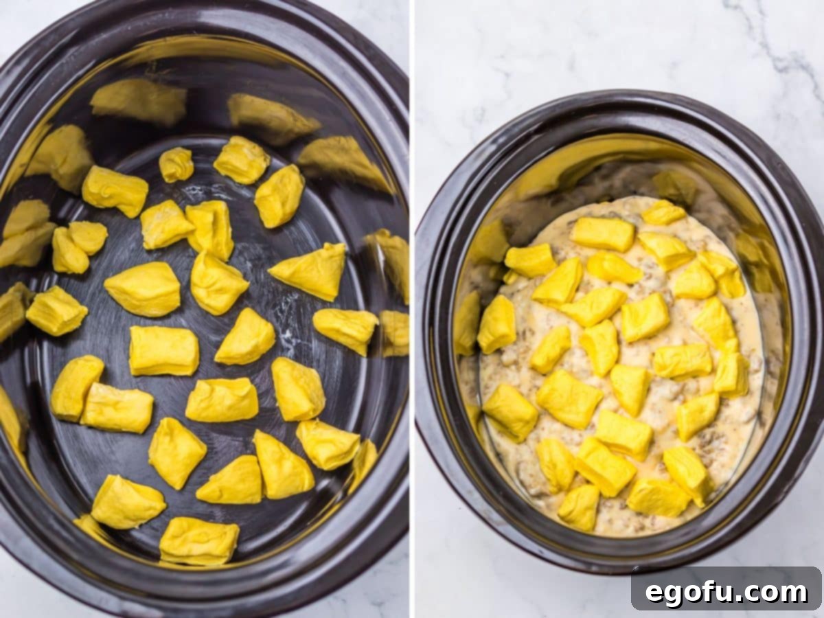 Biscuits on the bottom of a Slow Cooker, followed by layers of gravy with more biscuit dough pieces on top, illustrating the casserole assembly.