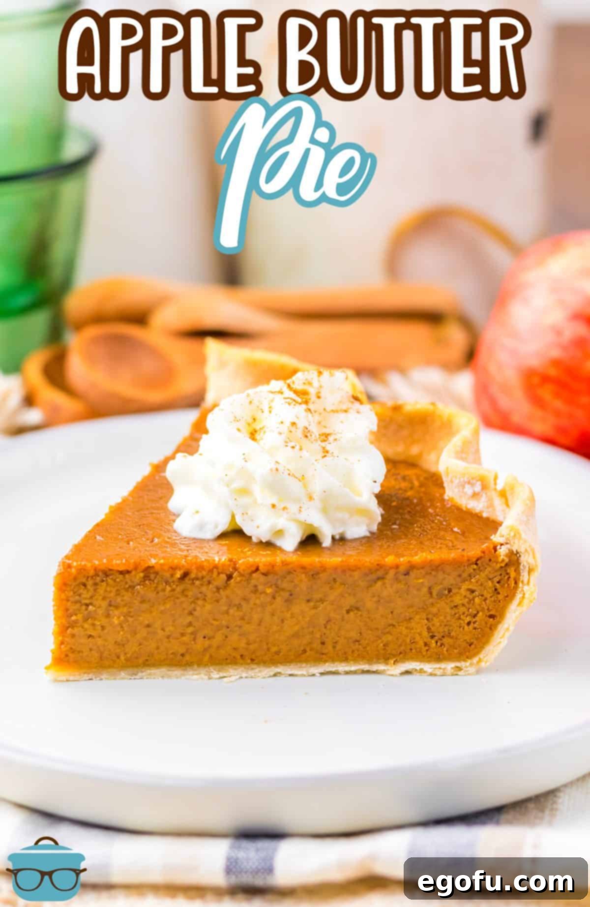 A dessert plate featuring a perfect slice of Apple Butter Pie, elegantly topped with fluffy whipped cream and a dusting of cinnamon, ready to be enjoyed.