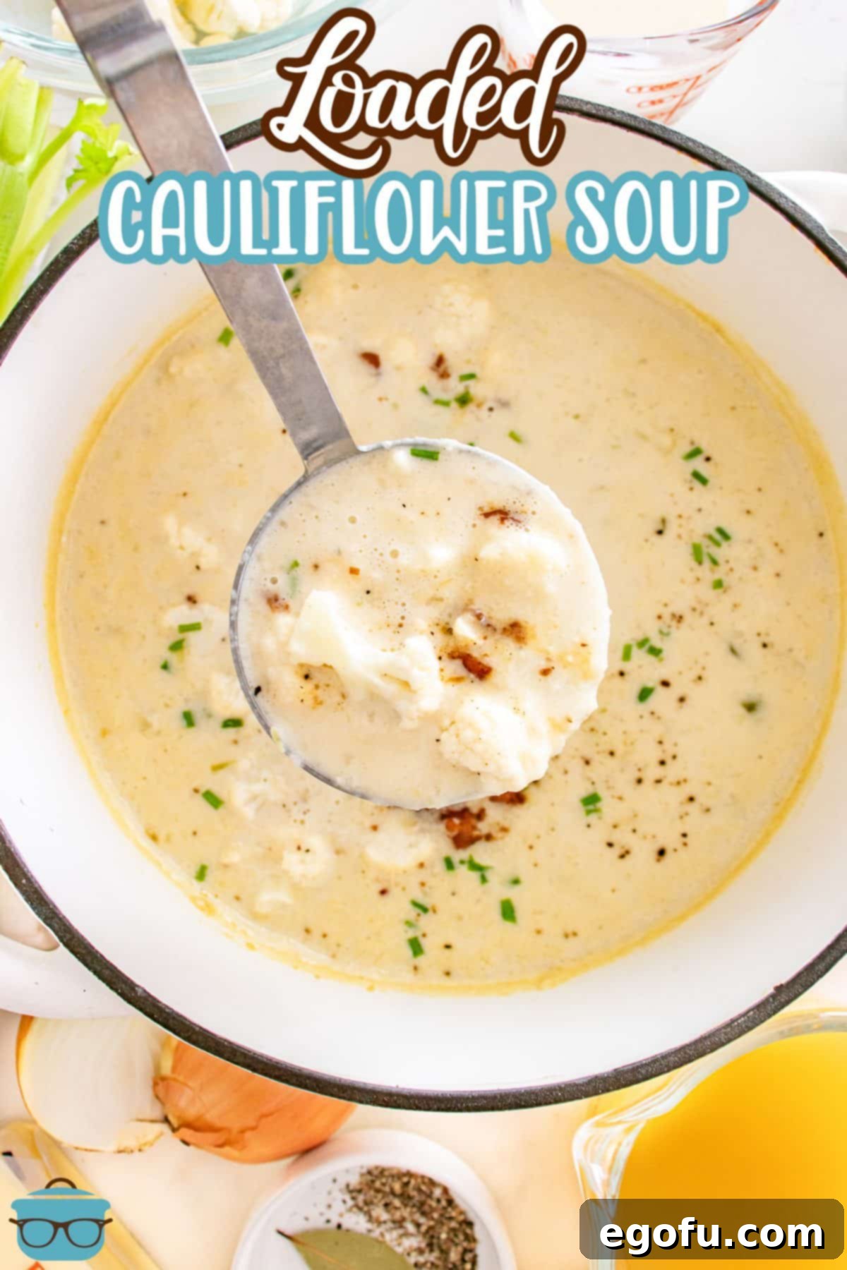 A soup ladle getting a scoop of creamy Loaded Cauliflower Soup from a large pot, showing its thick texture.