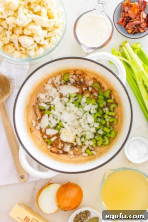 Butter, onions, celery, salt, and pepper being added to a cooking pot with bacon grease for a flavorful soup base.