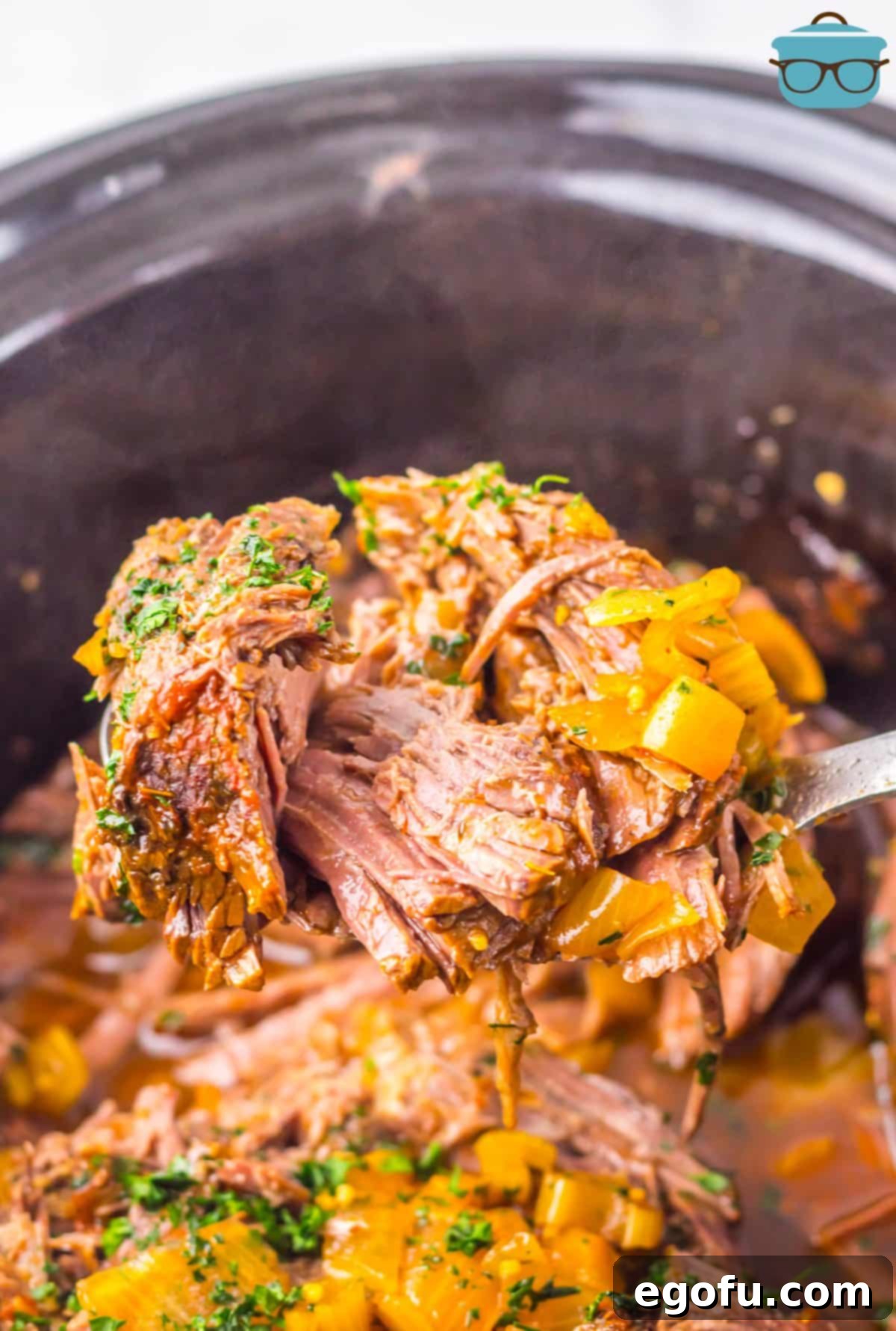 A serving spoon getting a scoop of Texas Roadhouse Pot Roast from the Slow Cooker, showcasing the tender beef and rich gravy.