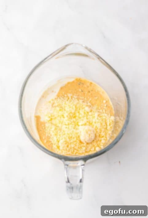 A cup with garlic powder, onion powder and paprika.