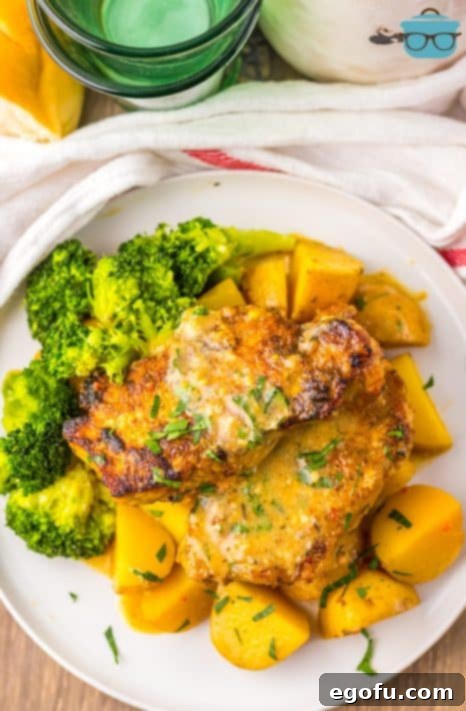 A plate of Garlic Parmesan Pork Chops and broccoli.
