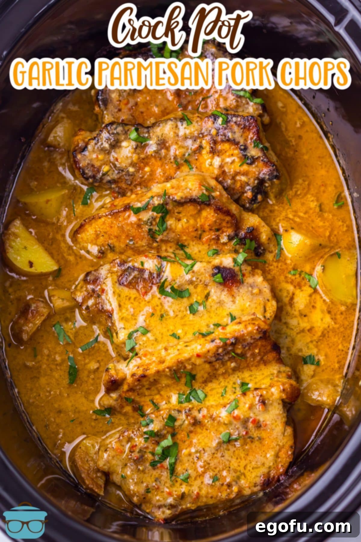 Looking down in a Slow Cooker with Garlic Parmesan Pork Chops.