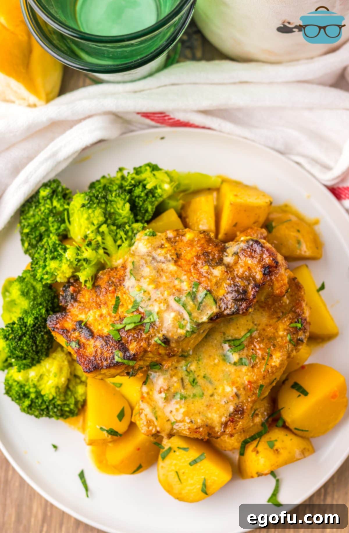 A plate of Garlic Parmesan Pork Chops and broccoli.