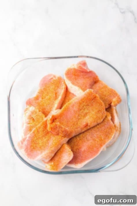 Seasoned pork chops in a bowl.