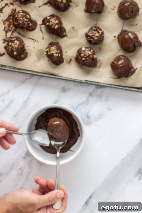 Truffles being dipped in chocolate.