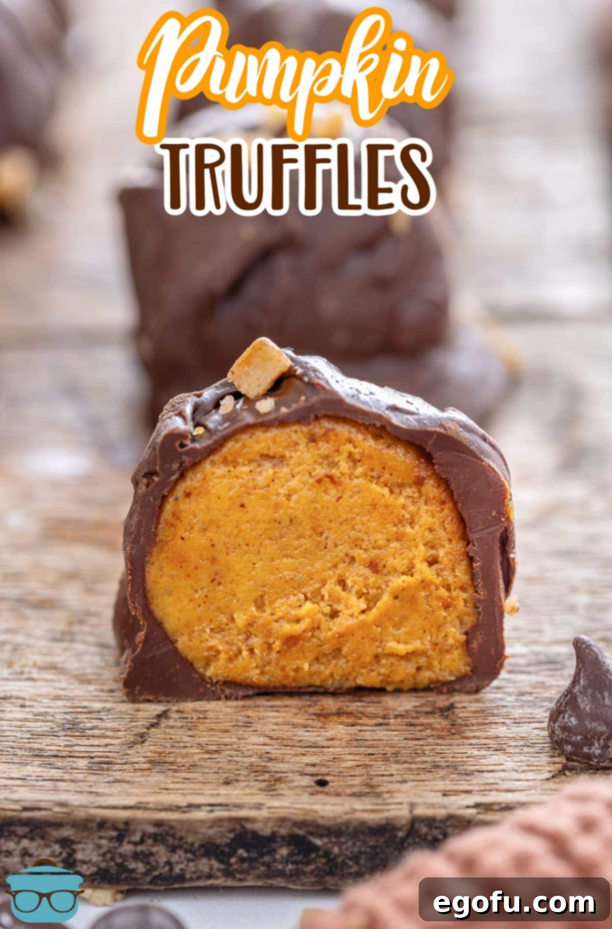 A few Pumpkin Truffles with one bit in half, revealing the creamy pumpkin filling.