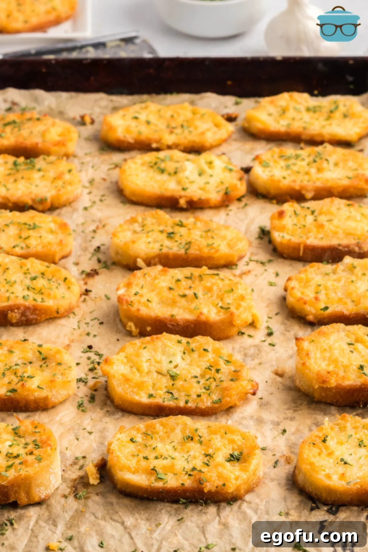 A lined sheet pan with Party Puffs and parsley.