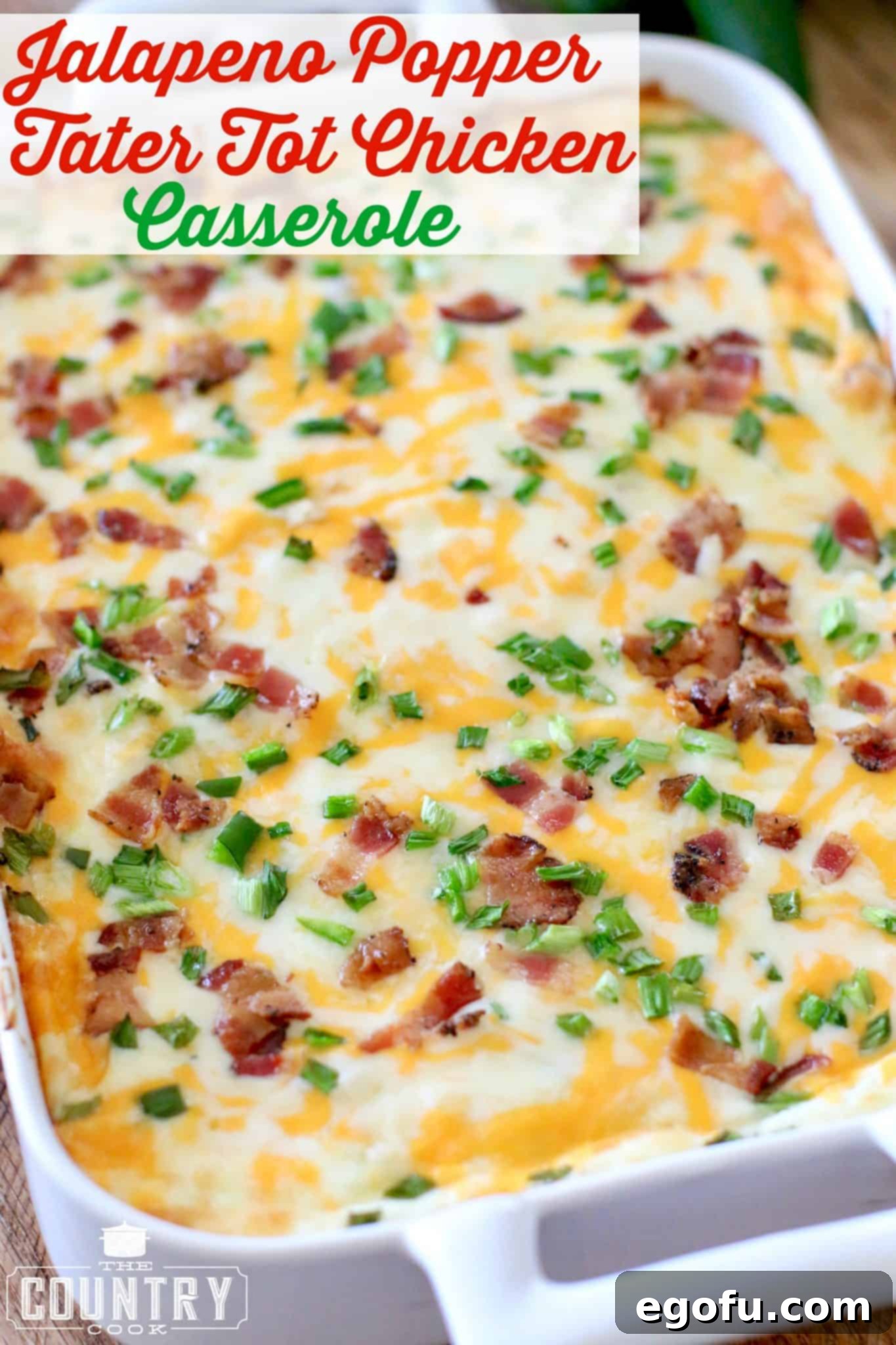 Jalapeno Popper Tater Tot Chicken Casserole shown fully baked with melted cheese in a white casserole dish.