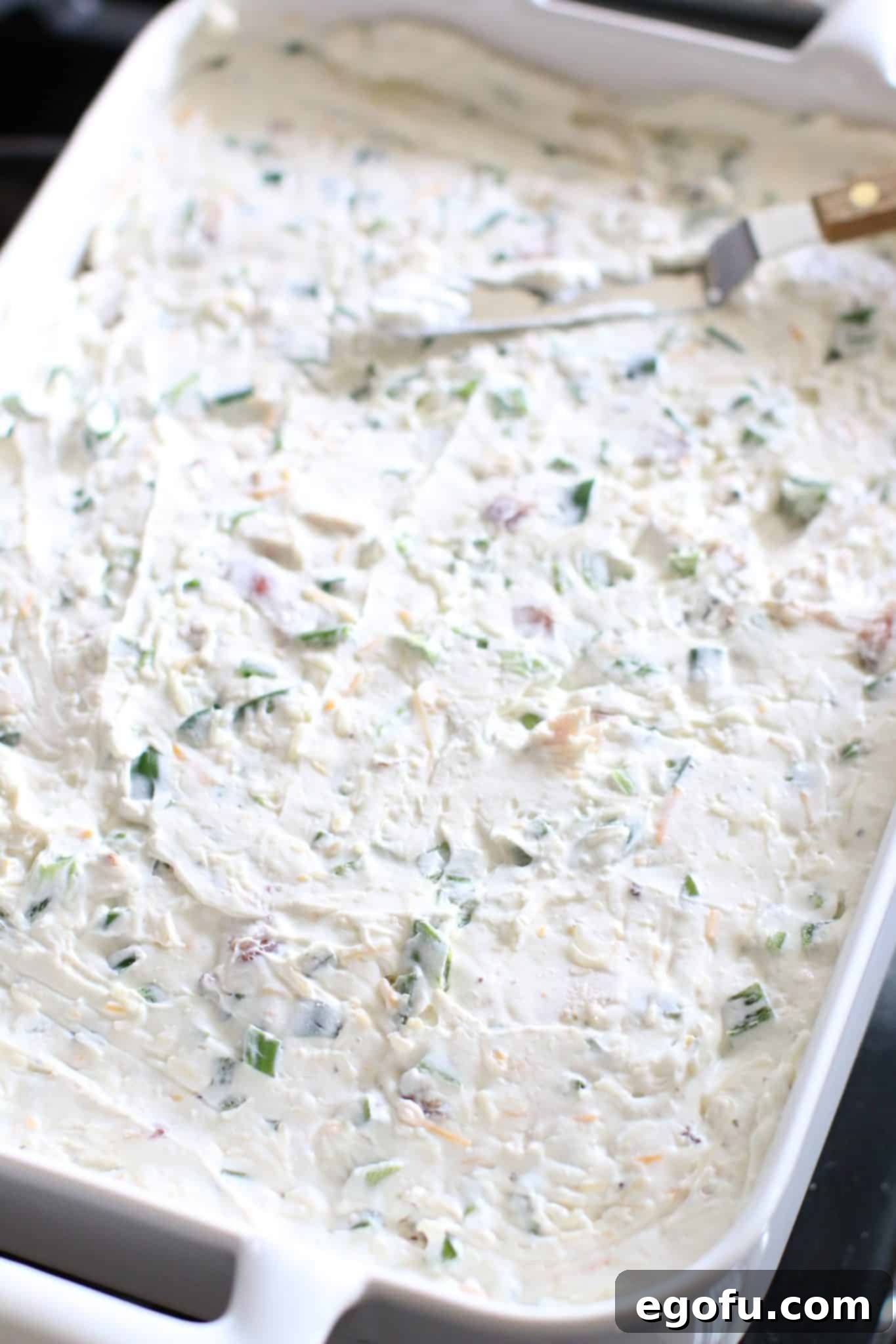 cream cheese mixture layered on top of tater tots and diced chicken.