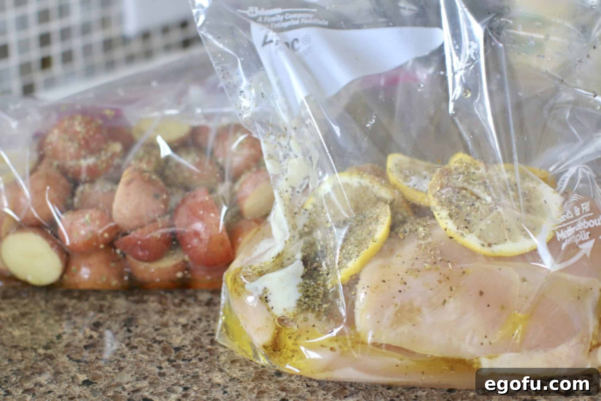 Marinade added to both bags holding chicken breasts and sliced red potatoes.