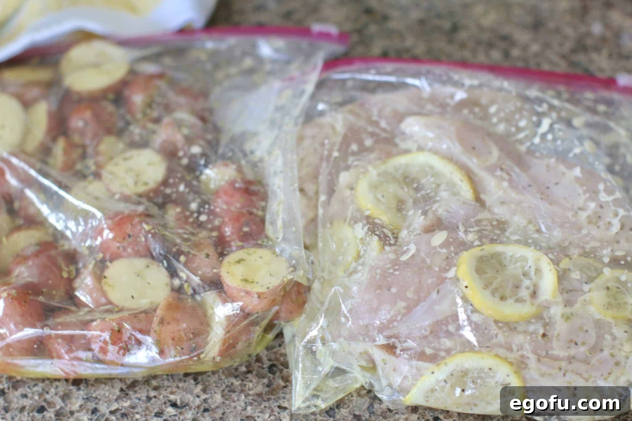 Marinade shown fully saturating chicken breasts and potatoes in zip top bags.