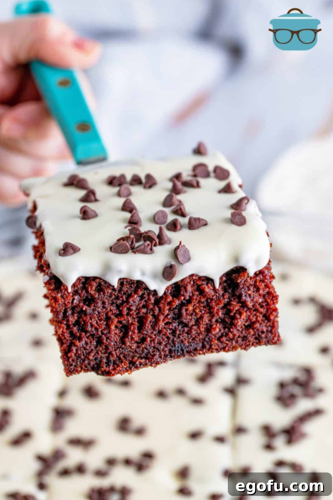 a slice of chocolate cake being held up by a spatula.
