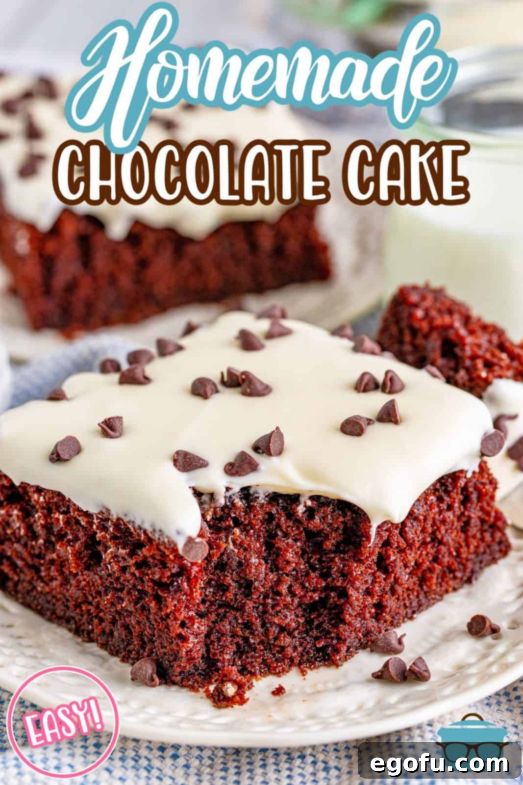 slice of chocolate cake on a white plate with a bite removed from the cake and mini chocolate chips sprinkled around.