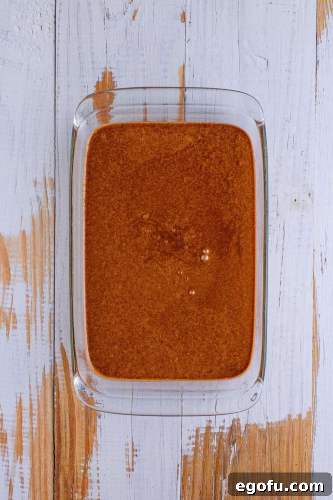 chocolate cake batter in a clear baking dish.