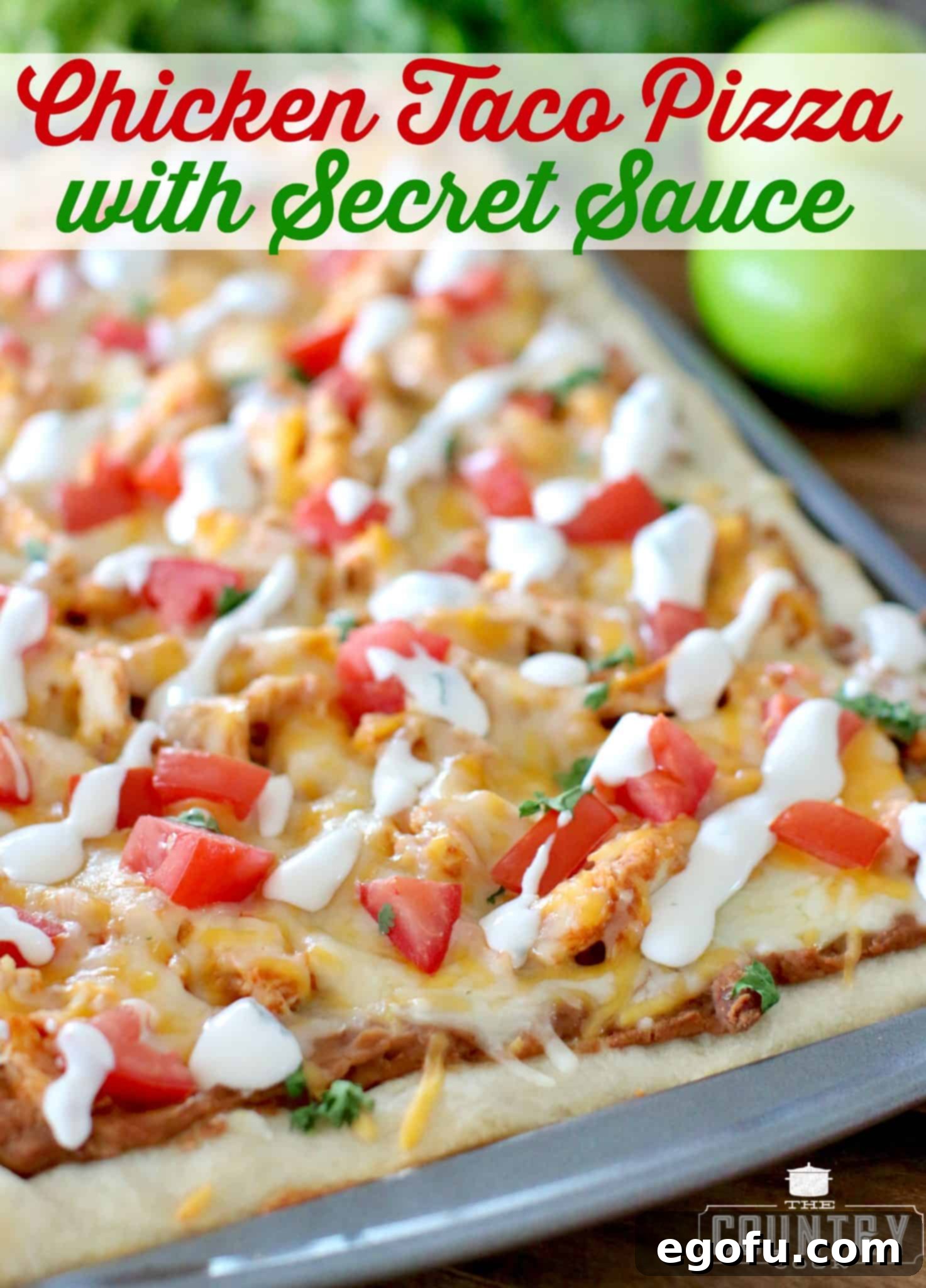 A close-up of a slice of Chicken Taco Pizza generously drizzled with the signature secret sauce.