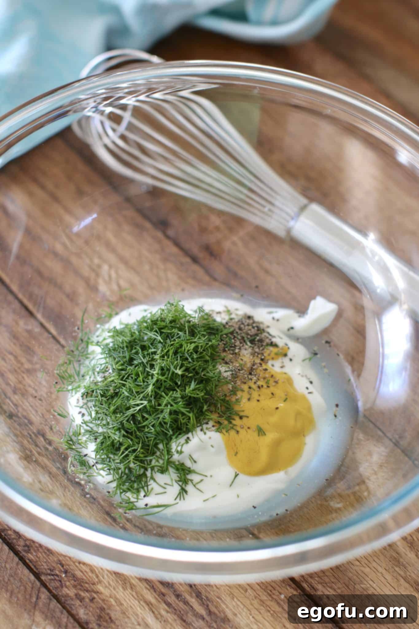 Ingredients for the dressing being whisked in a bowl