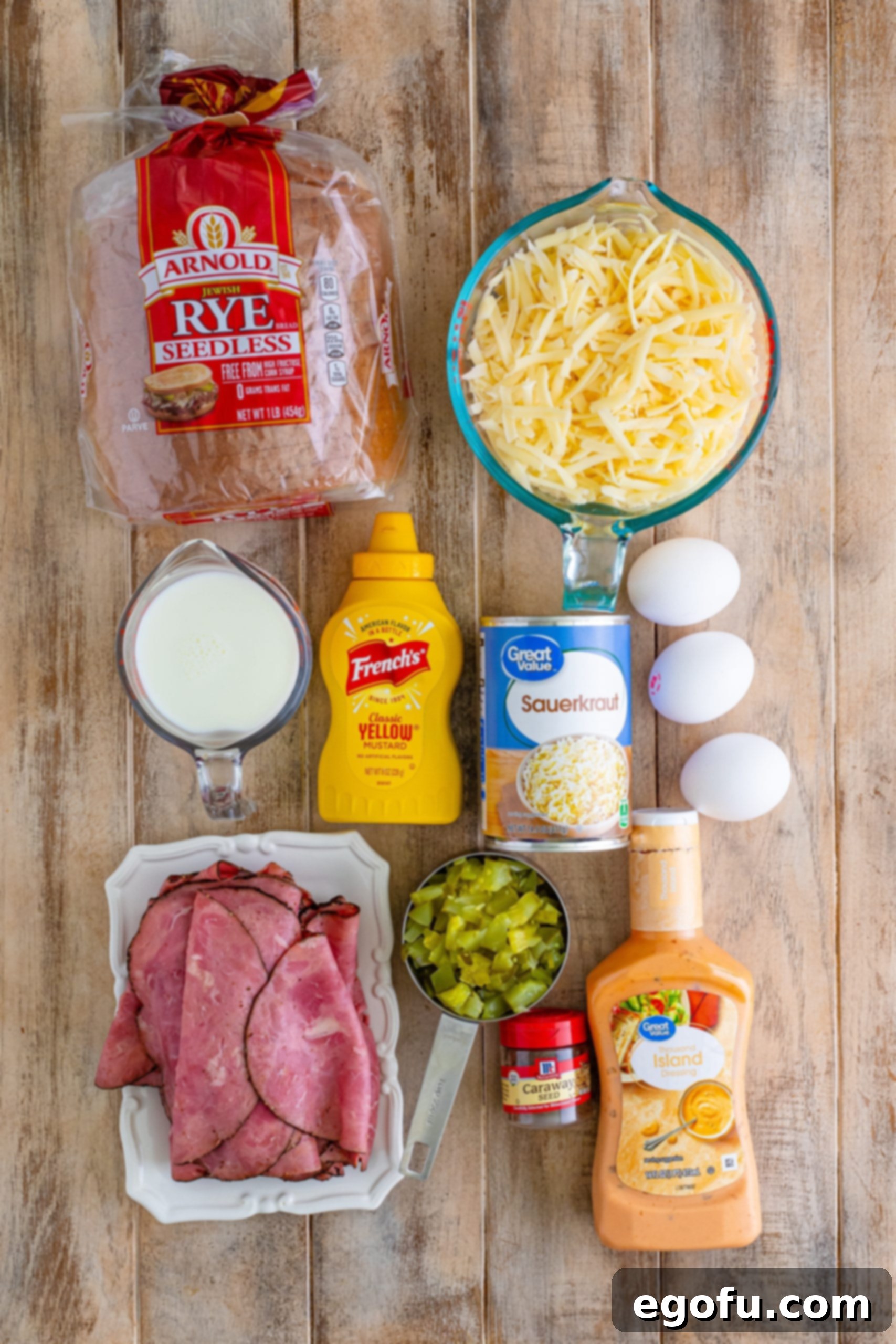 Rye bread, thinly sliced pastrami or corned beef, sauerkraut, shredded Swiss cheese, caraway seeds,
chopped dill pickle,
milk, eggs, thousand island dressing, and
yellow mustard.