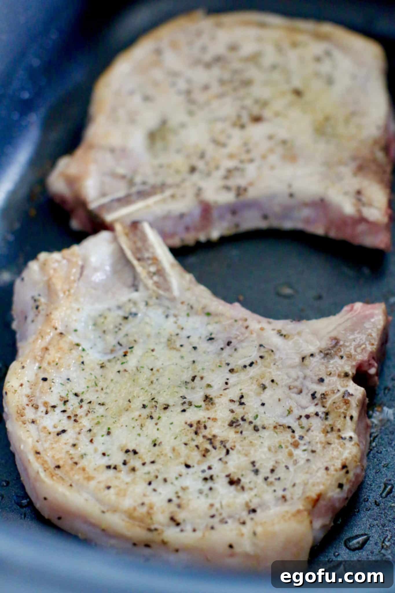 Browning pork chops in a skillet, first step for the Crock Pot Smothered Pork Chops and Potatoes