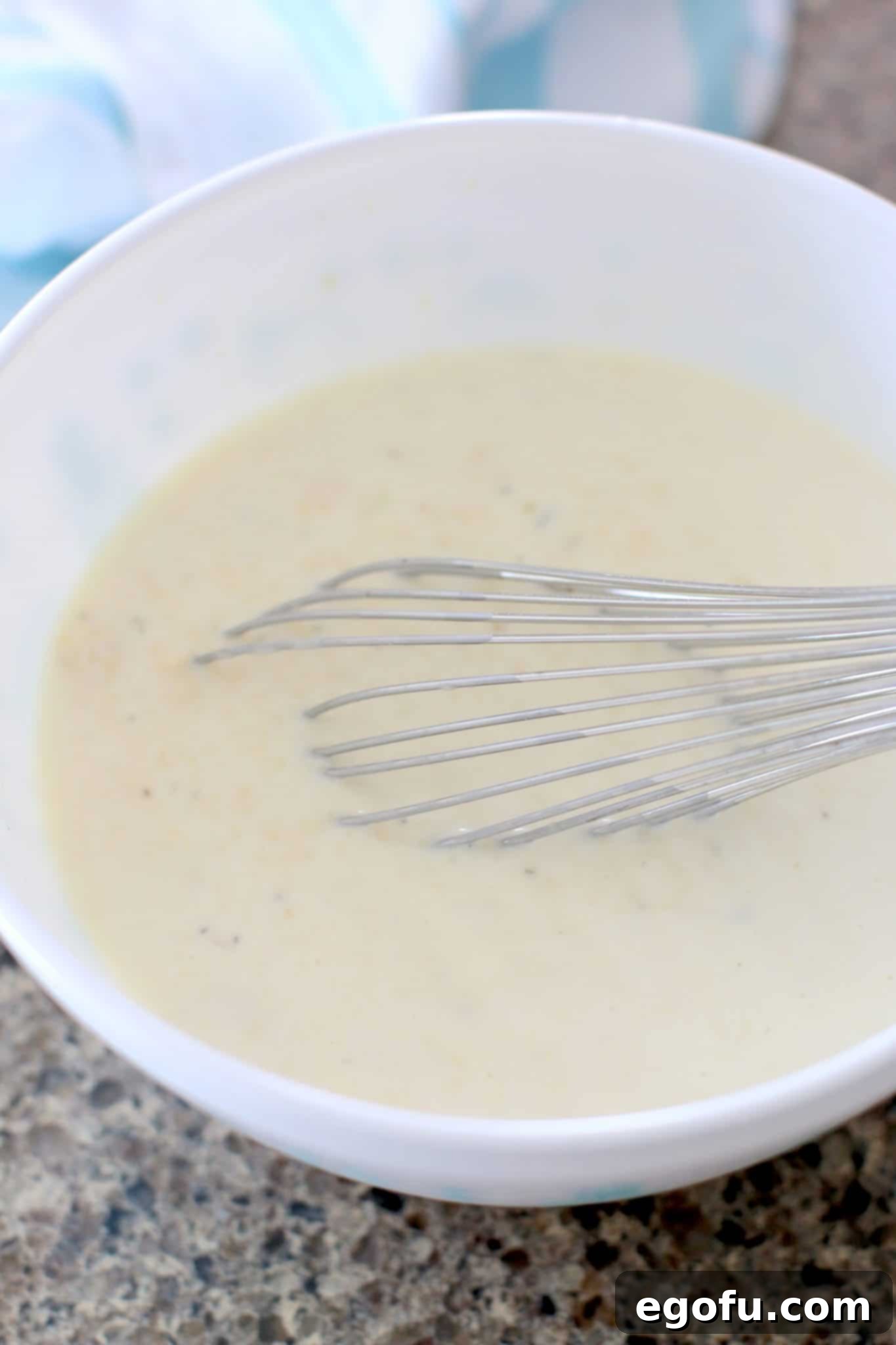 Creamy sauce mixture for Crock Pot Smothered Pork Chops and Potatoes in a bowl
