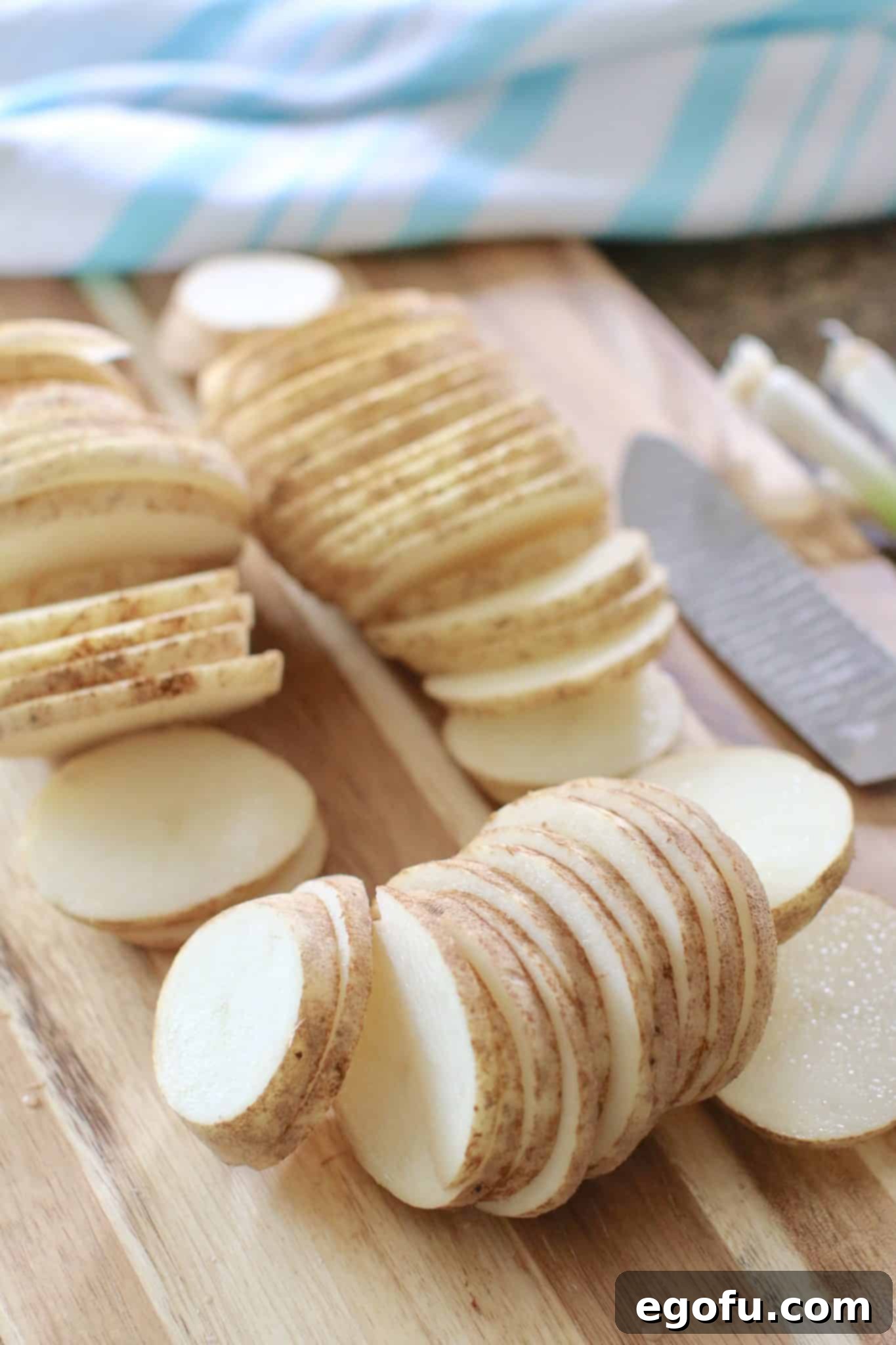 Sliced potatoes and chopped onions ready for layering in Crock Pot Smothered Pork Chops and Potatoes