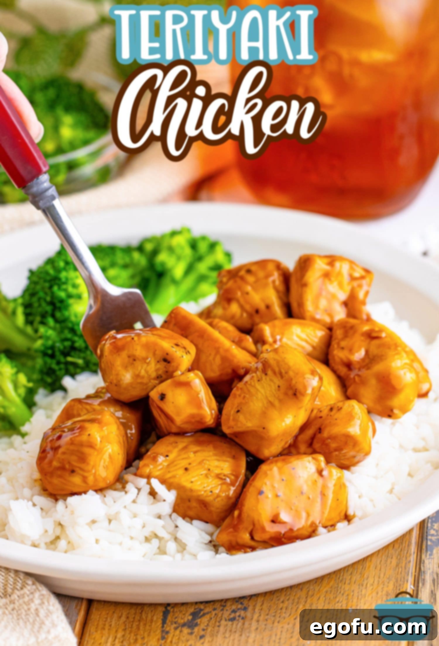 Effortless Teriyaki Glazed Chicken 3 A fork on a plate with chicken, broccoli and Teriyaki Chicken.