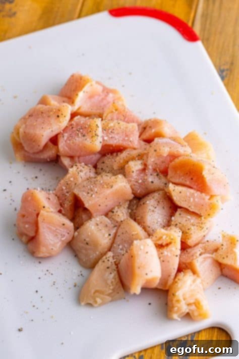 Effortless Teriyaki Glazed Chicken 9 raw diced chicken breast seasoned with salt and pepper.