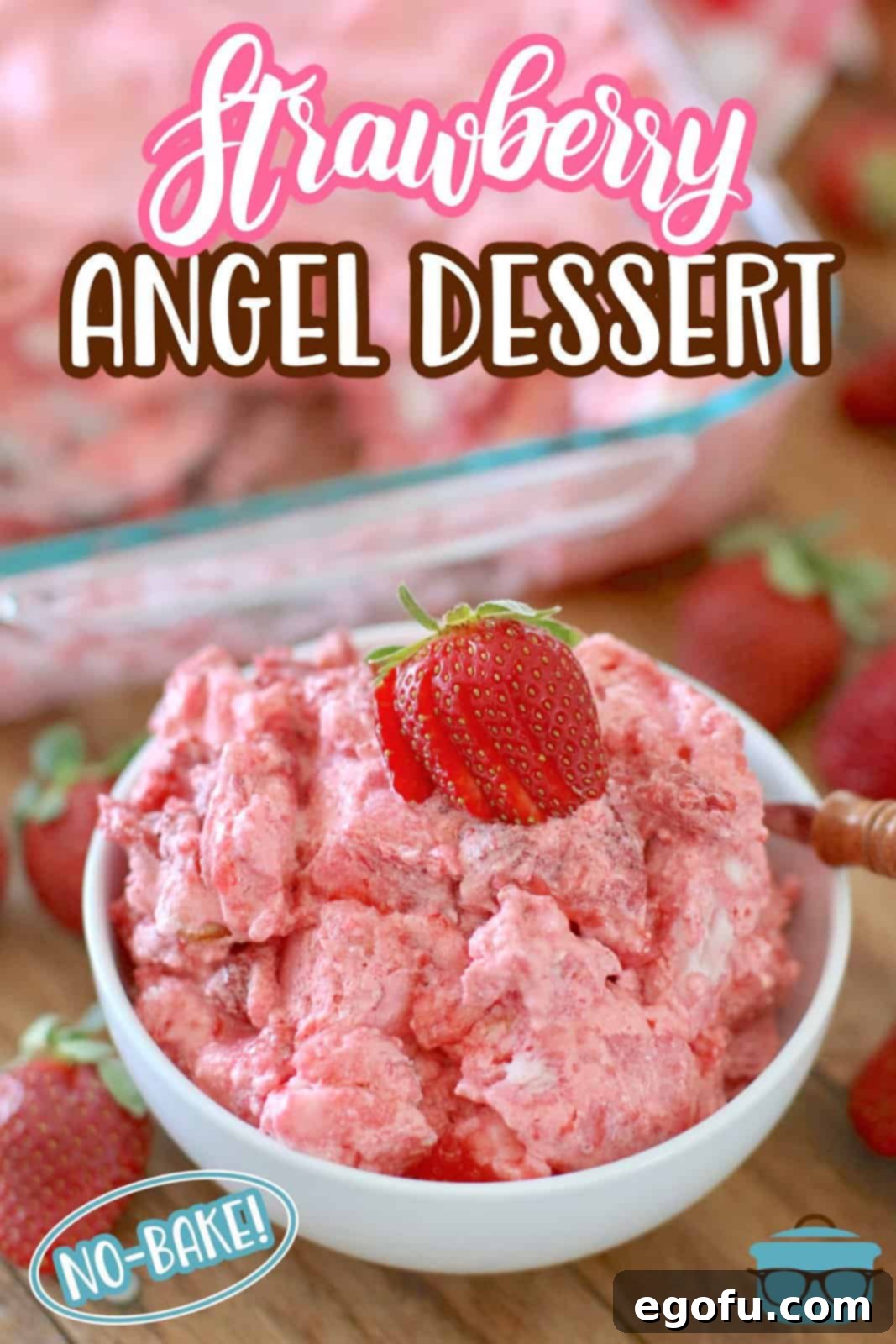 Strawberry Angel Delight 3 A white bowl filled with strawberry angel food cake dessert, elegantly topped with a fresh sliced strawberry, ready to be enjoyed.