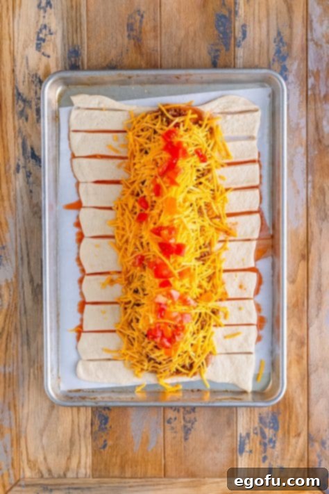 Tomatoes, cheese, ground beef, and beans layered on pizza dough.