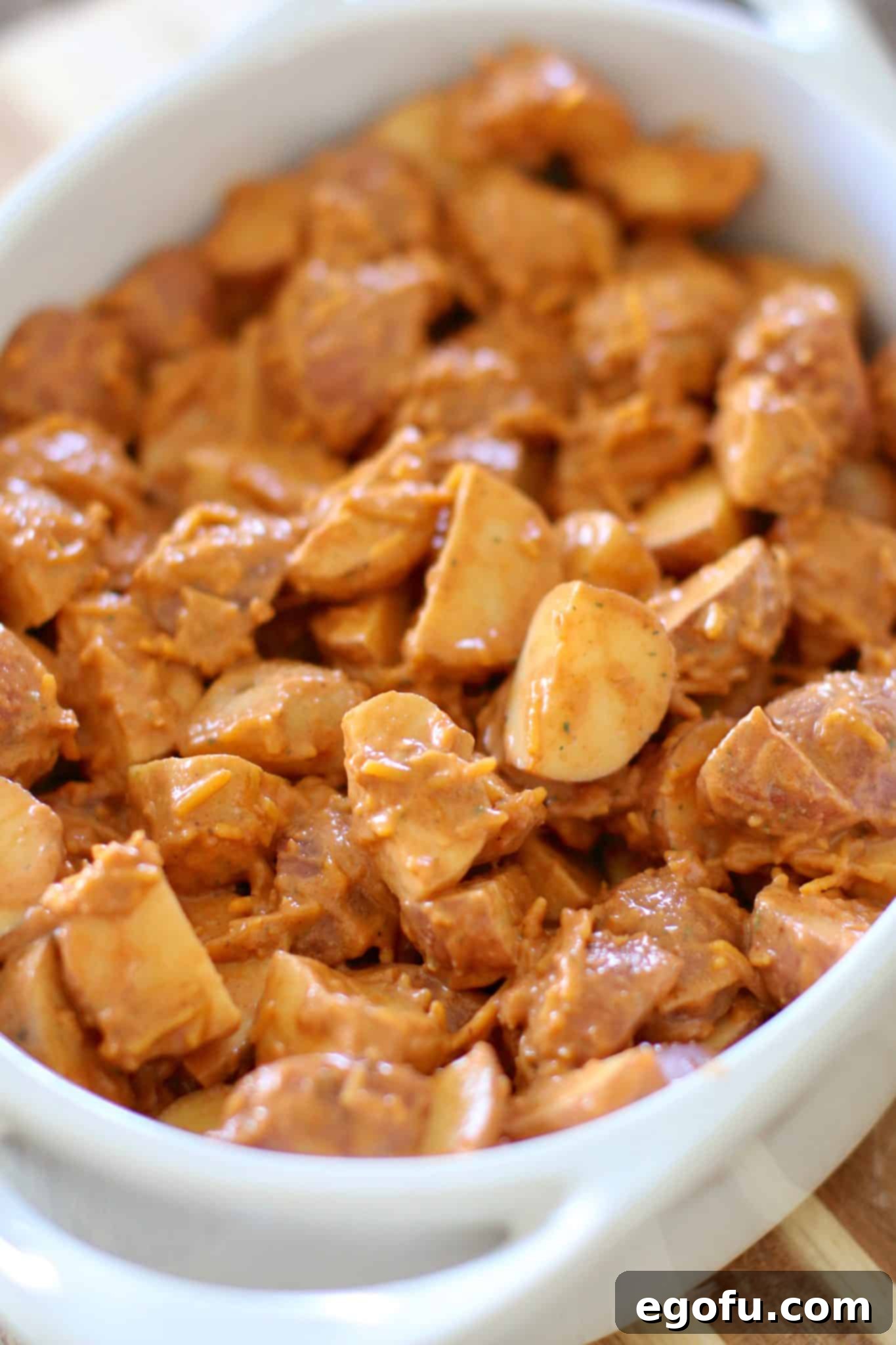 taco seasoned halved potatoes shown in a white oval baking dish with handles.
