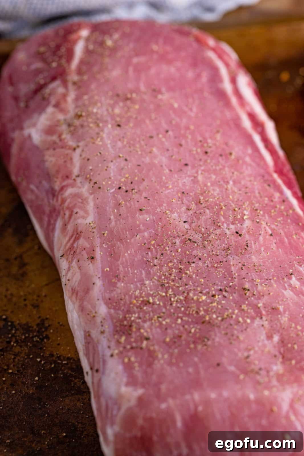 Fall-Apart Mississippi Pork Perfection 6 A pork roast shown with freshly ground black pepper on top, ready for searing.