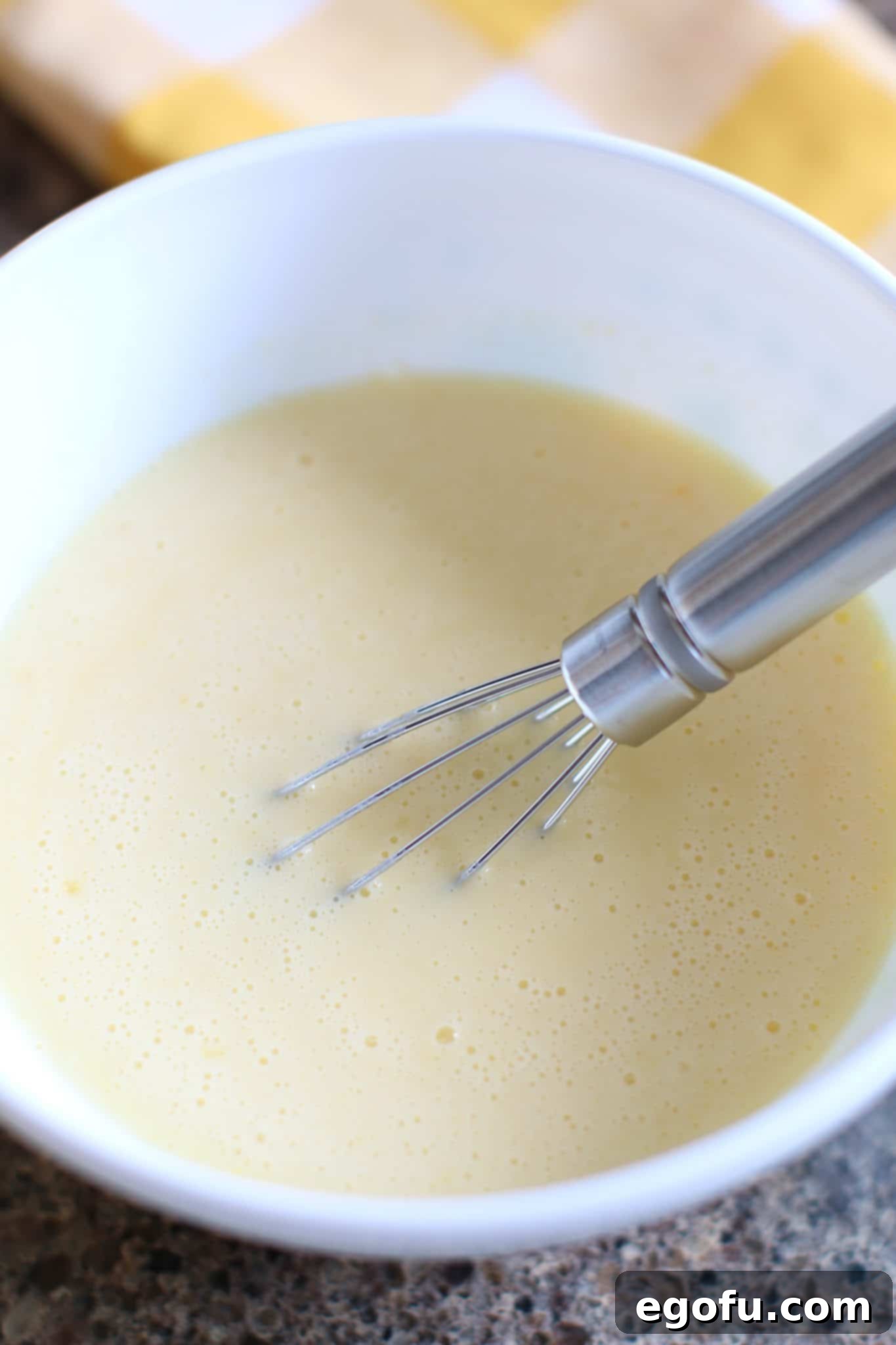 Cold milk and banana instant pudding whisked together in a bowl, beginning to thicken.