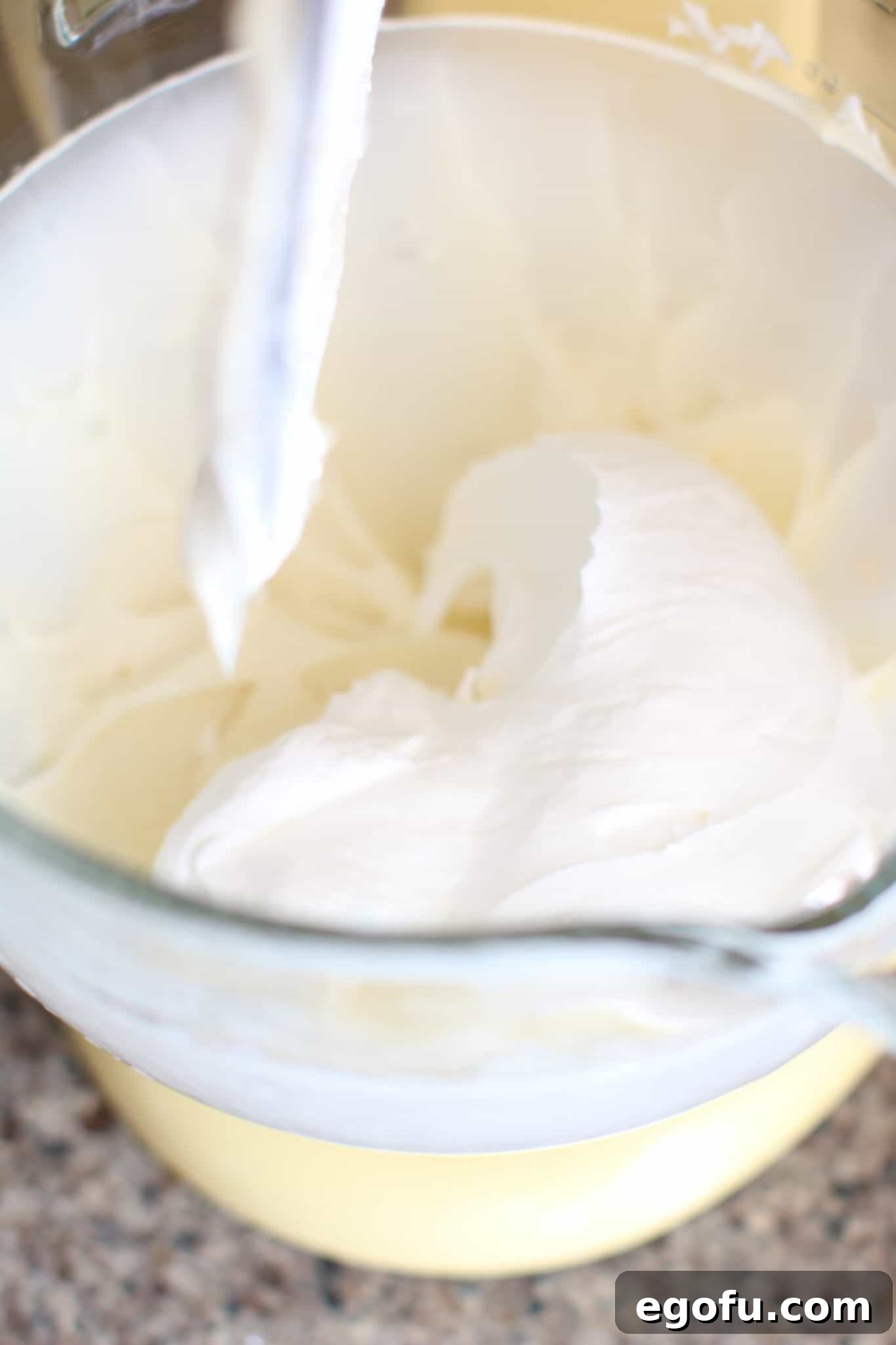 Half of the whipped topping carefully folded into the cream cheese and sugar mixture.