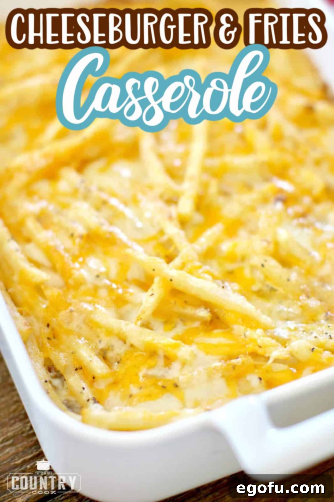 Cheeseburger and Fries Casserole recipe from The Country Cook. Fully cooked casserole shown with fries and melted cheese.