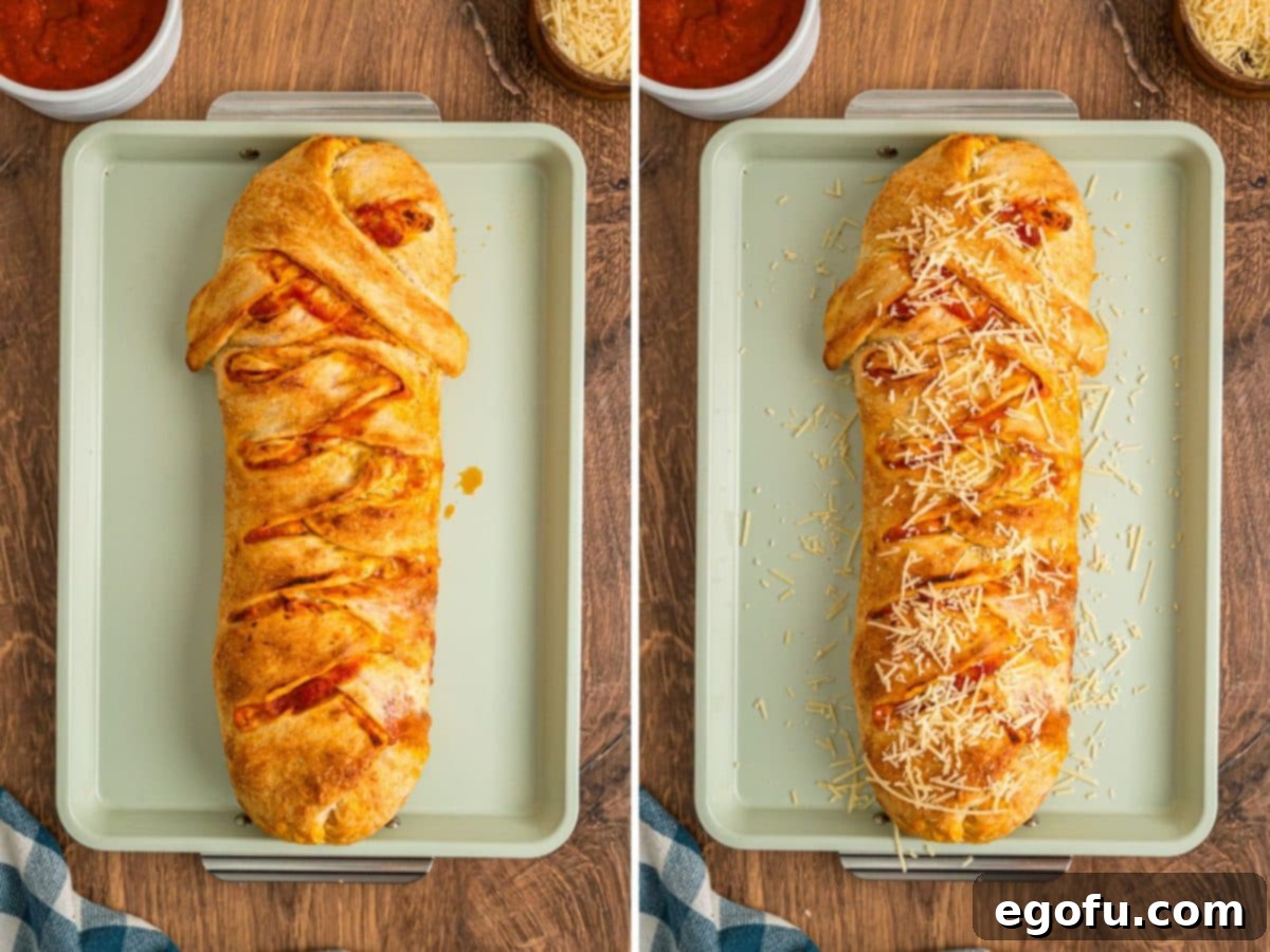 A baked Stromboli and cheese garnishing it.