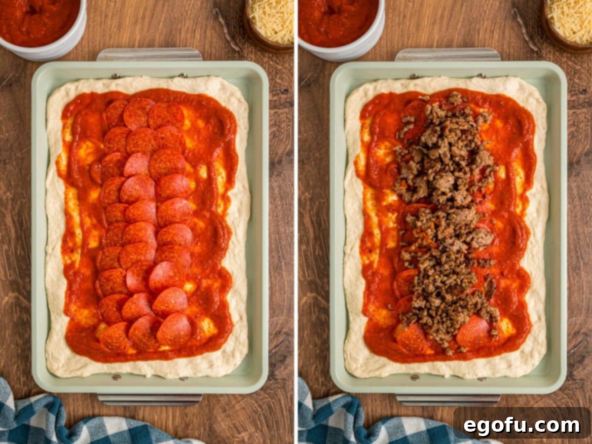 Pepperoni and sauce with sausage on pizza dough.