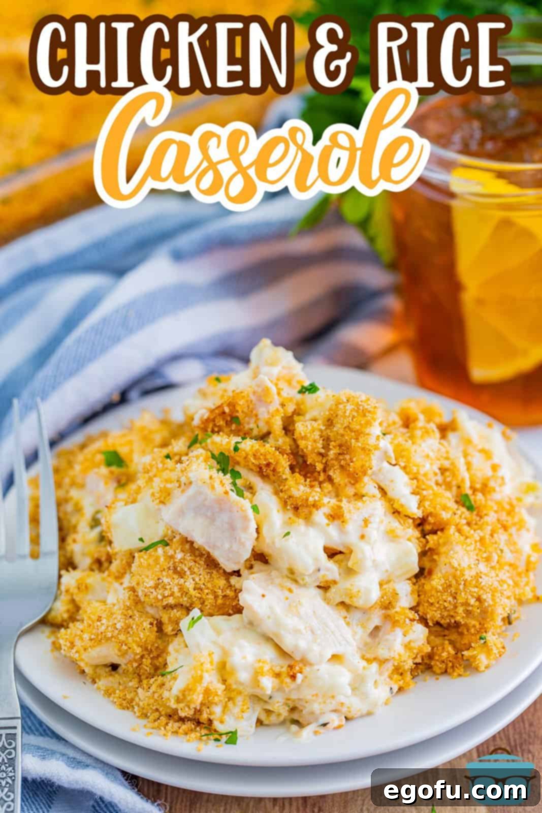 A perfectly portioned serving of golden brown chicken and rice casserole on a round white plate, ready to be enjoyed.