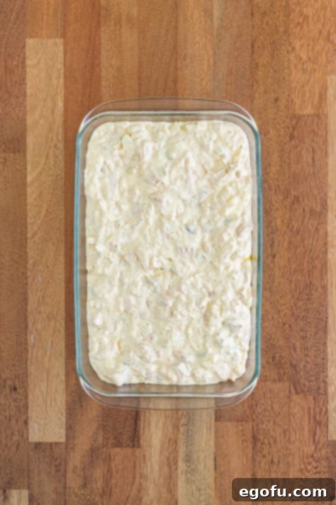 chicken and rice mixture spread into a baking dish.