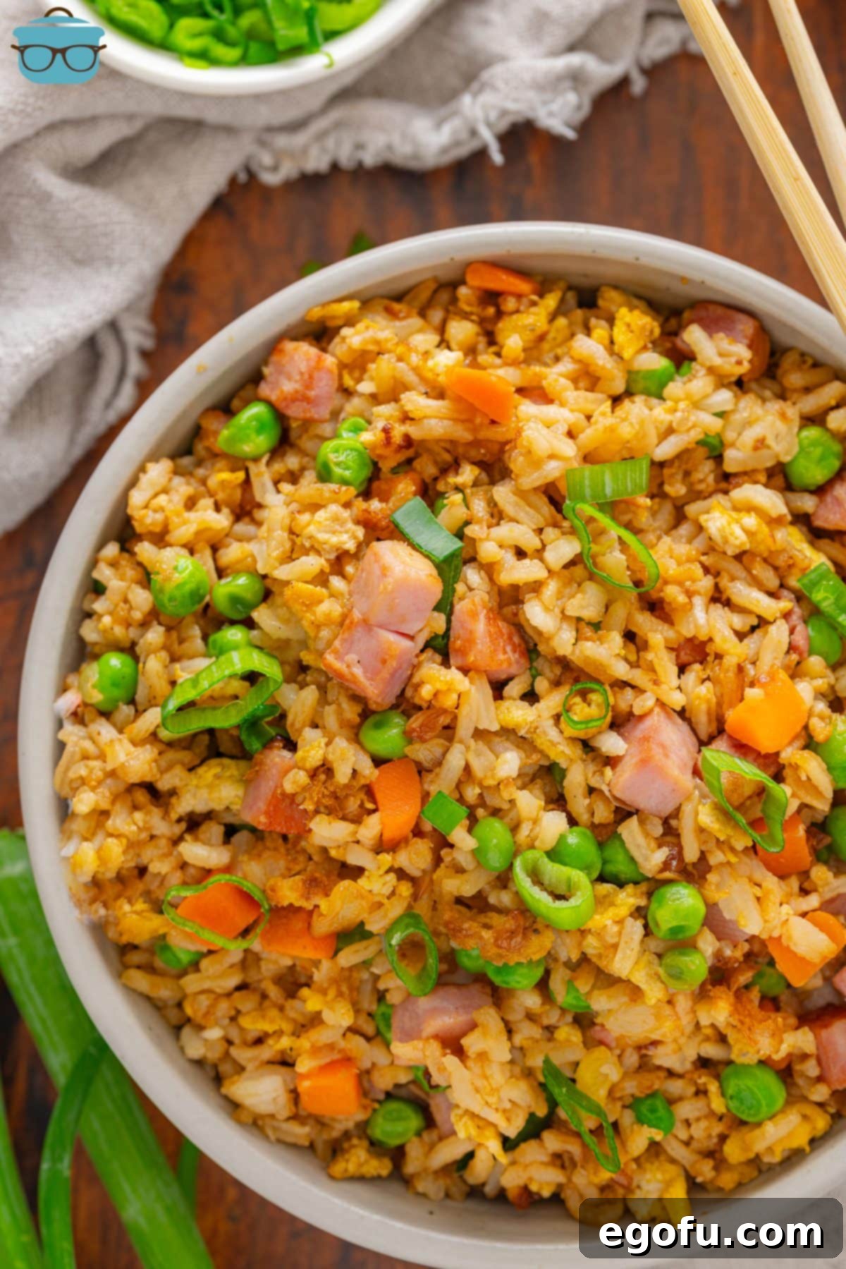 Golden Ham Fried Rice 2 A large serving bowl full of Ham Fried Rice, garnished with fresh green onions, inviting and delicious.