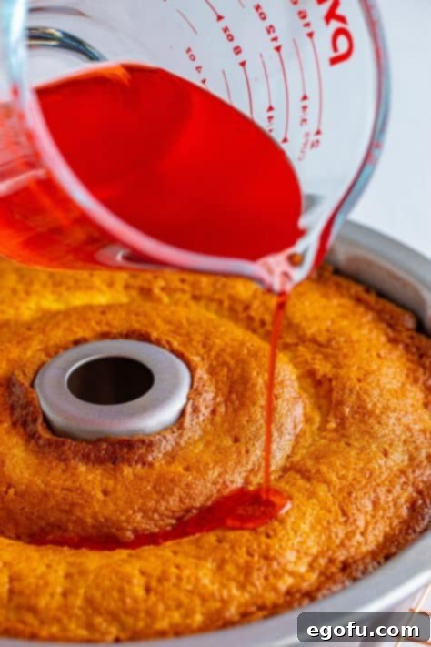 Juice being poured over a cake.