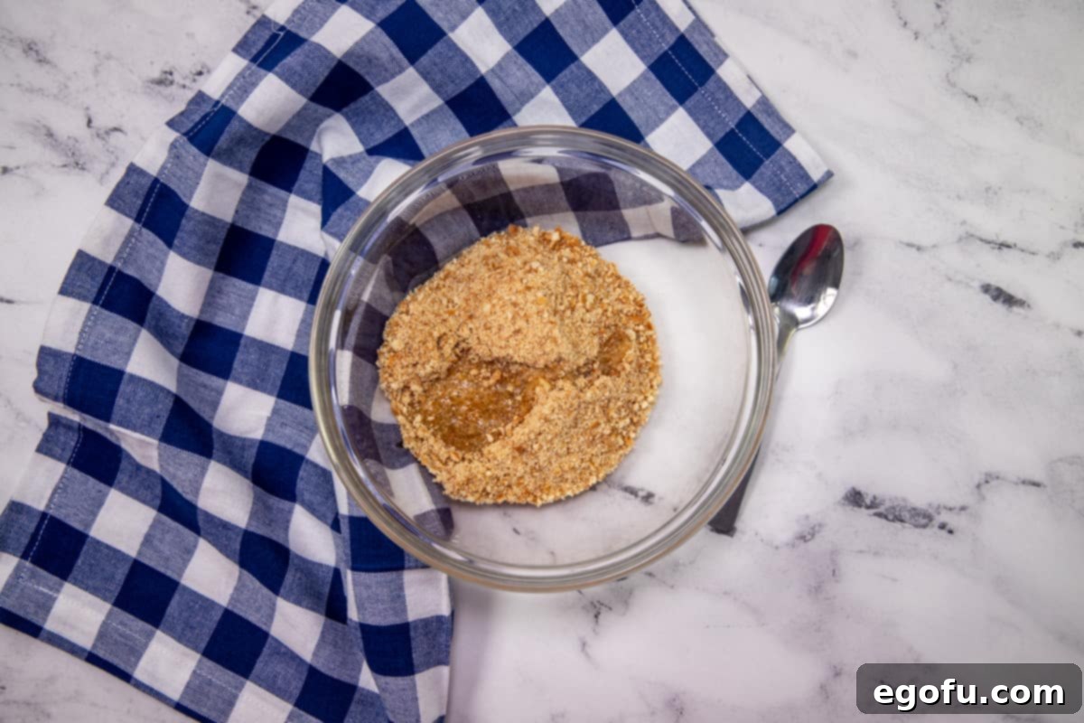 Grandma B's Blueberry Icebox Bars 6 melted butter added to crushed vanilla wafers in a bowl.