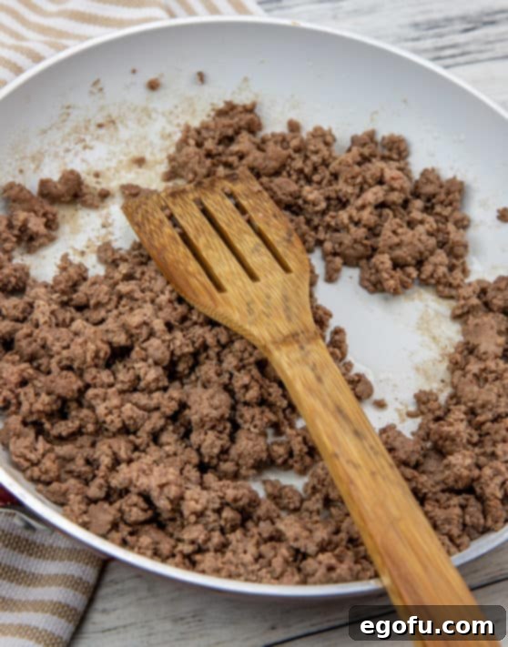 ground beef being cooked in a skillet.