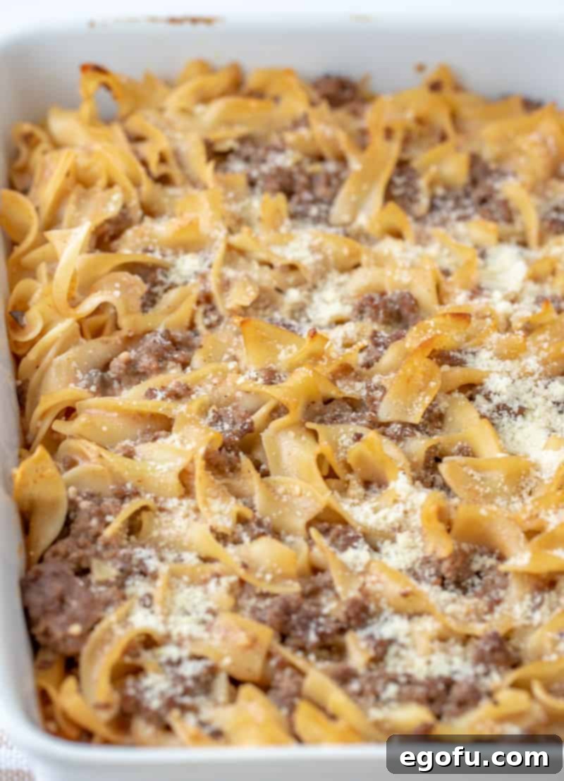 Amish Country Casserole in a baking dish with Parmesan cheese on top.