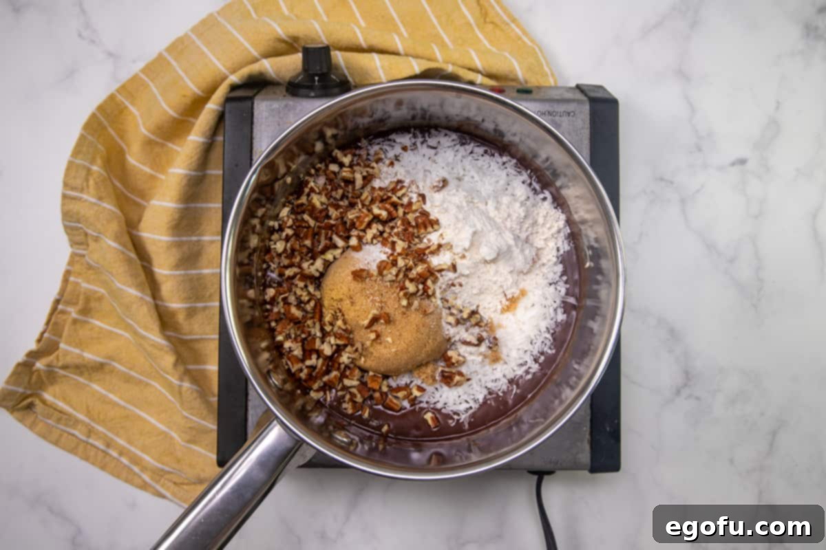 coconut, flour, brown sugar and chopped pecans added to saucepan. 