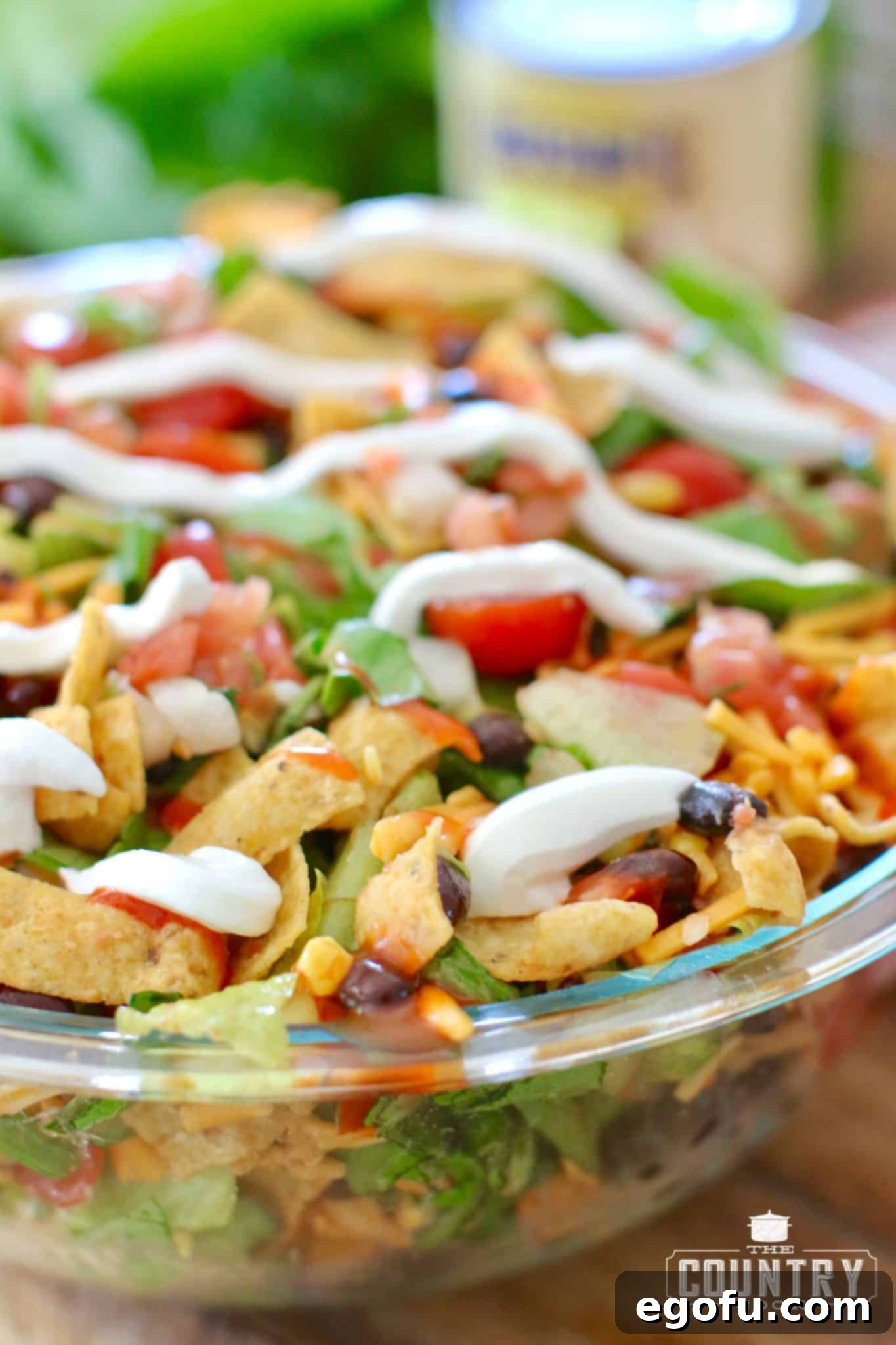 Frito Fiesta Taco Salad 6 Vegetarian Taco Salad in a Large Bowl with a generous dollop of Sour Cream, showcasing another delicious topping option.