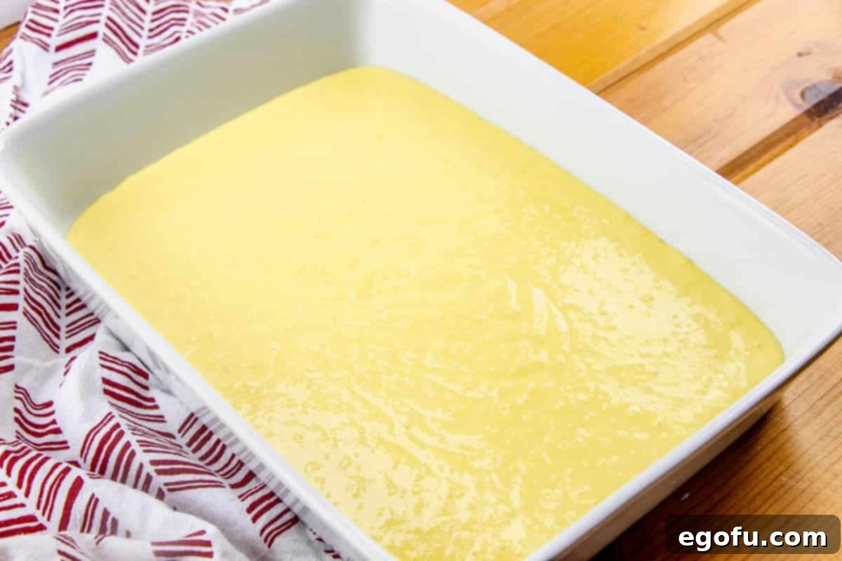 lemon cake mix batter in a white baking dish.
